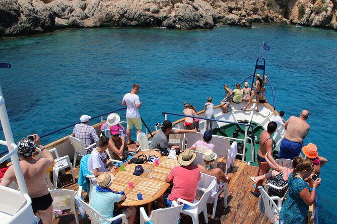 Half-Day Odyssey Guided Boat Safari with Lunch in Cyprus - Swimming beneath the red cliffs at Cape Pyla